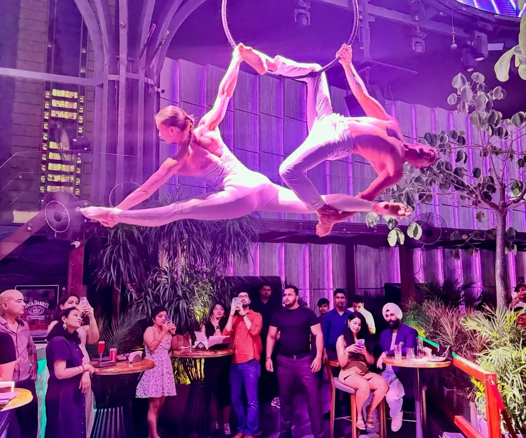 A beautiful moment from a duo performance on the aerial hoop. This kind of synchronized work relies on both artists having a deep understanding of their flexibility and control, especially in poses like this shared split.
