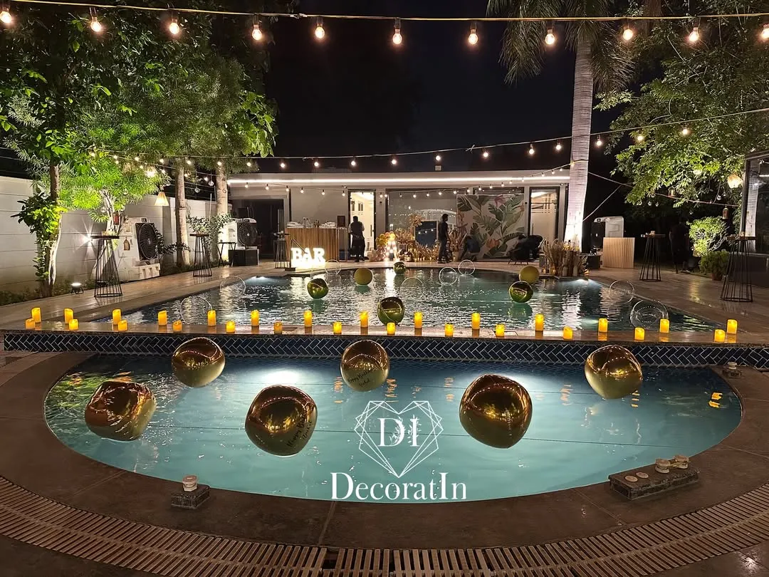 For a fabulous 40th birthday, we transformed this poolside into a chic, modern oasis. The combination of string lights, floating golden orbs, and warm candle lighting created an unforgettable ambiance for an adult celebration.