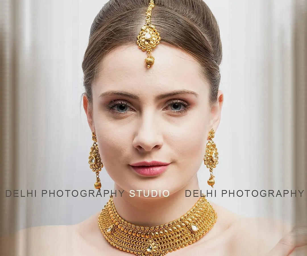 My jewelry photography focuses on capturing the fine details and true color of each piece. This close-up of a model wearing a traditional gold necklace set is perfect for product pages and promotional banners.