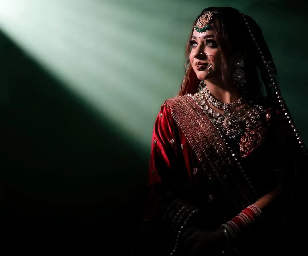I love playing with light to create something truly magical. This dramatic bridal portrait uses a single beam of light to highlight the bride's anticipation and elegance just moments before her ceremony.
