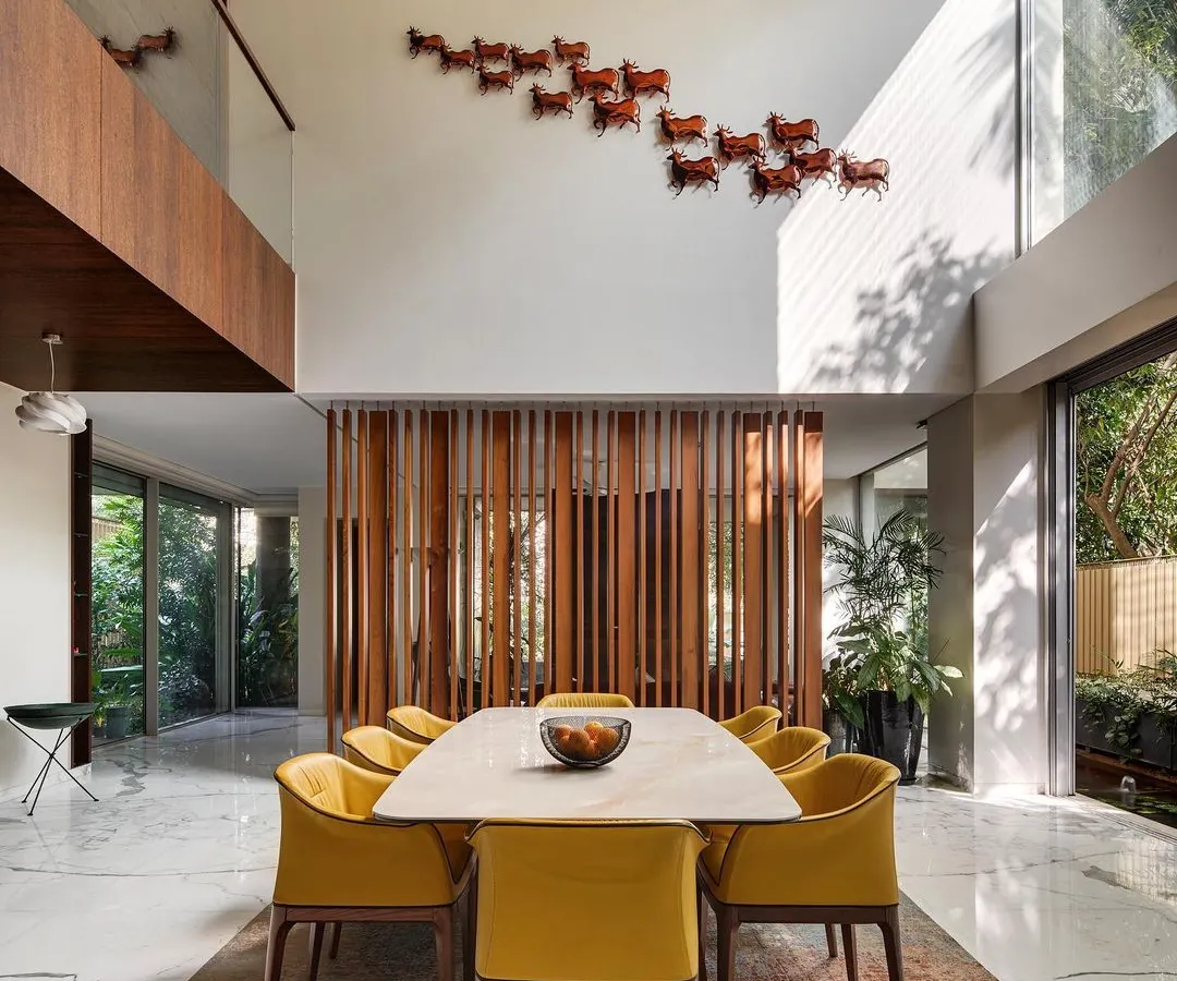 I design homes with spaces that breathe. This double-height dining area in the Kanasu residence connects vertically and opens horizontally to the outdoors, creating a sense of grandeur and seamless flow for family life.