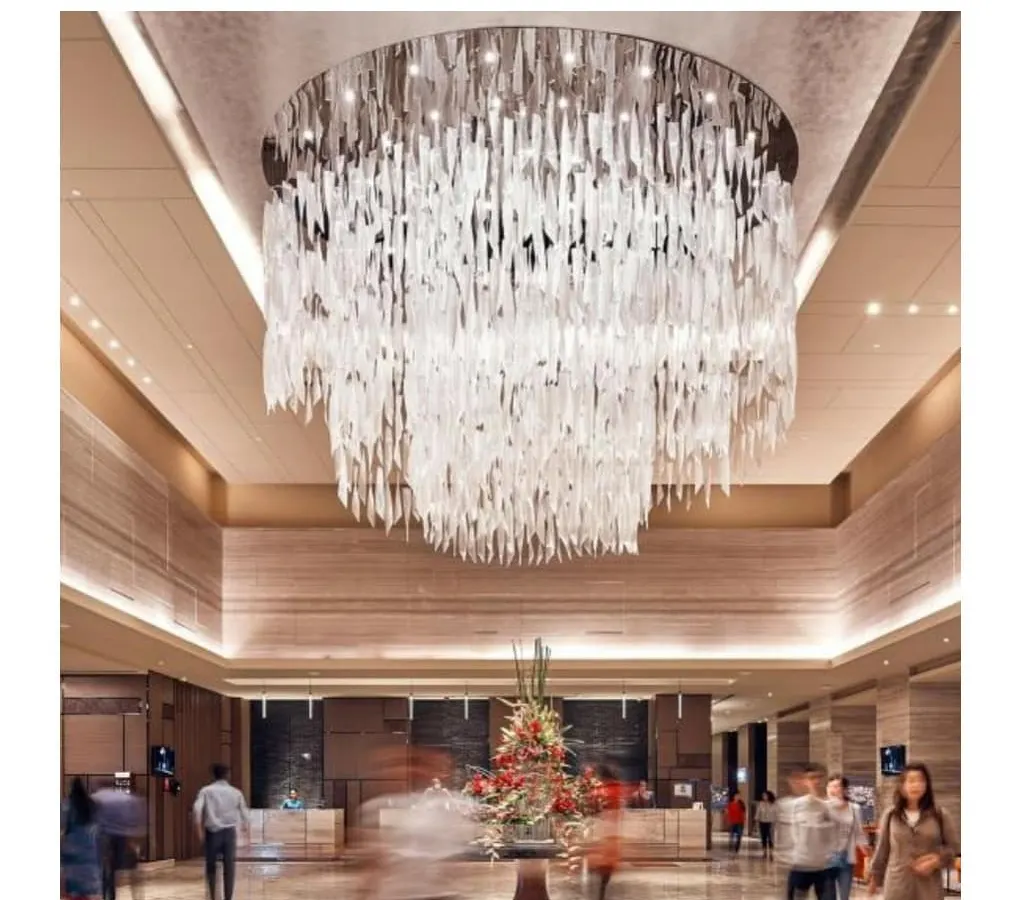 We believe lighting is sculpture. This large-scale, custom chandelier serves as the dramatic focal point in the lobby of the Sheraton Hotel, demonstrating our ability to design and execute grand, experiential hospitality spaces.