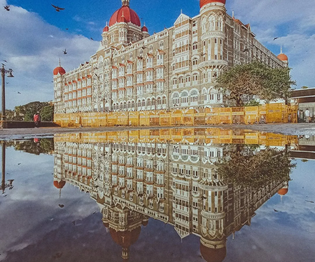 This is one of my favorite shots, where the monsoon rain turns the streets into a perfect mirror for the iconic Taj Mahal Palace. It feels like capturing a dream, a perfect reflection of Mumbai's heritage and beauty.