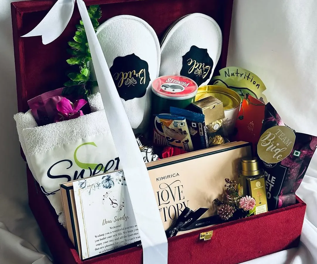 The ultimate bridal hamper, curated to pamper the bride-to-be. This luxurious red velvet keepsake box is filled with personalized slippers, a custom towel, gourmet chocolates, and premium skincare, making it the perfect gift for her big day.