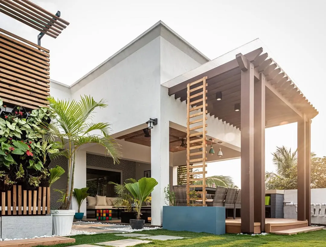 This is a perfect example of how we can transform an open area into a complete outdoor living room. With a sturdy pergola for shade, comfortable seating for lounging, and lush greenery, this has become the family's favorite summer spot.