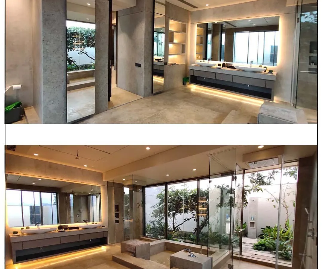 This bathroom blurs the line between indoors and outdoors, creating a private spa experience. The design incorporates a sunken jacuzzi, dual vanities, and a glass wall that opens to a secluded garden, allowing our client to connect with nature while enjoying modern comforts.