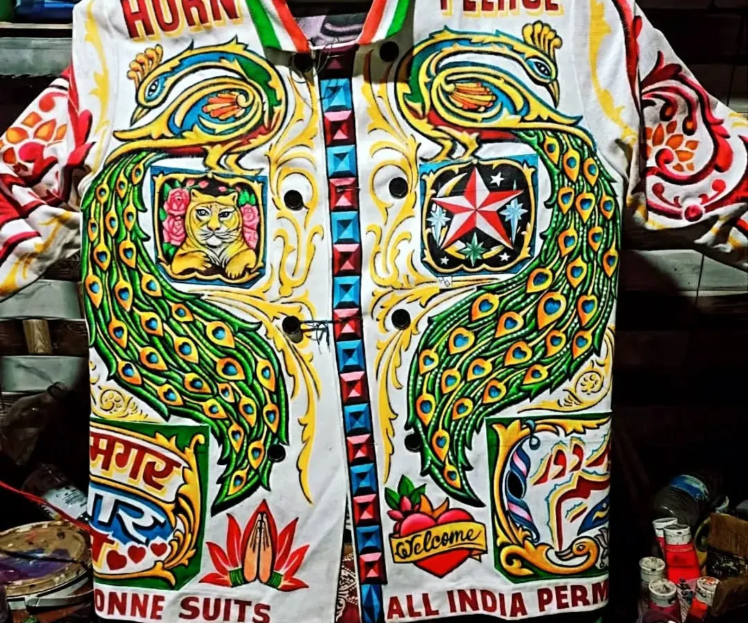 A true celebration of Indian truck art on a jacket. This piece is packed with iconic elements like the 'Horn Please' slogan, majestic peacocks, and multi-lingual text, all hand-painted in dazzling colors. It’s a wearable piece of desi pop culture.