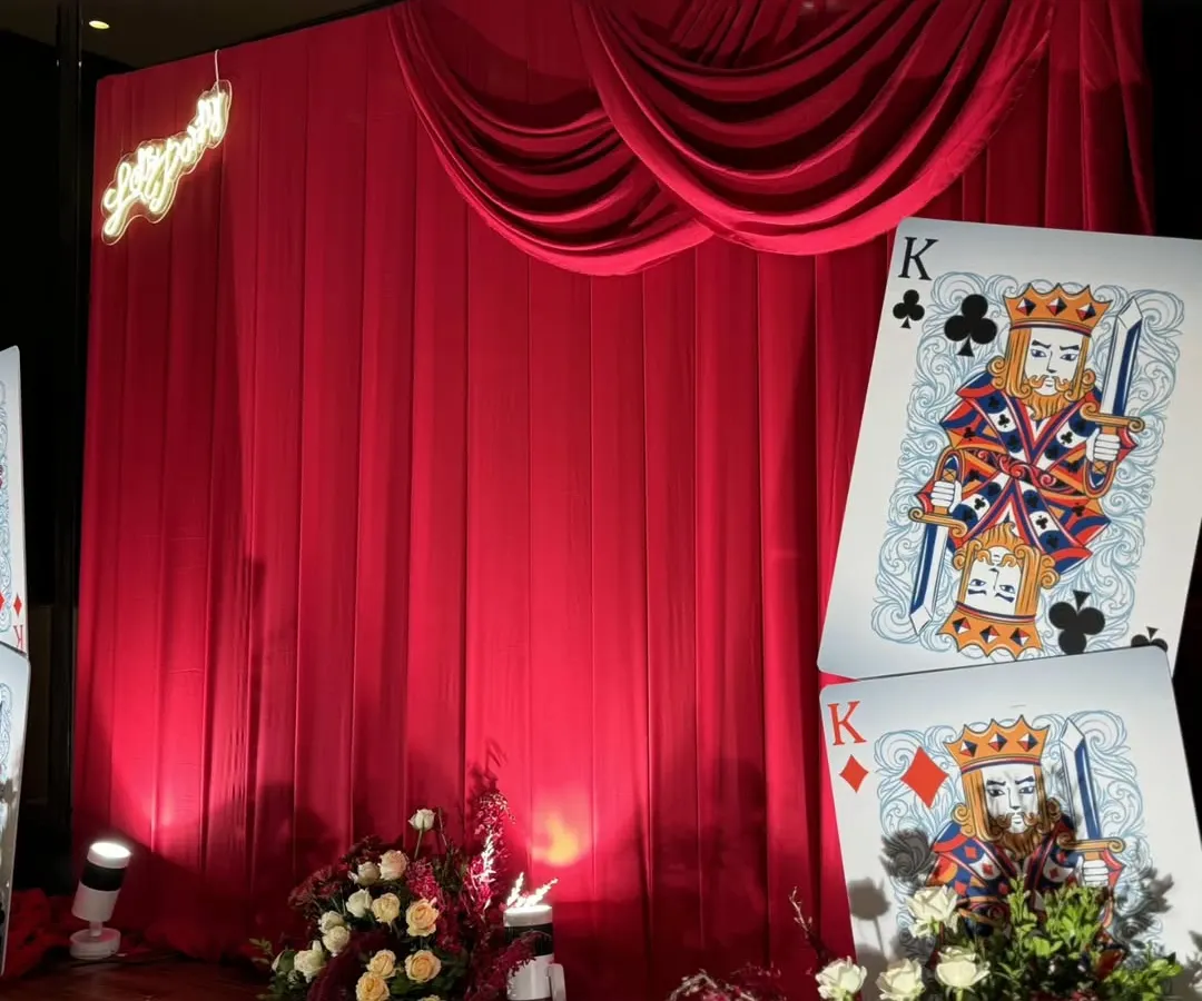 We transformed a milestone birthday into a glamorous Casino Night, where every detail, from the rich red drapes to the custom life-sized playing cards, was designed for an evening of sophisticated fun and high-stakes excitement.