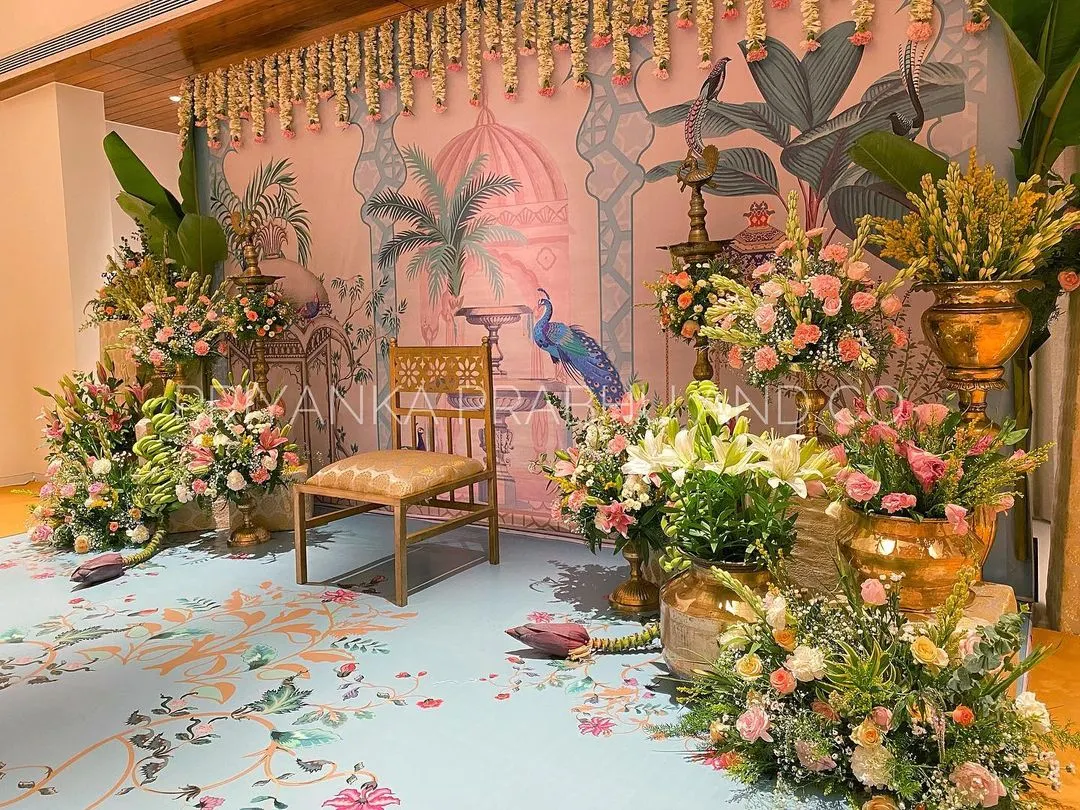 I adore bringing unique artistic visions to life, like this Pichwai-inspired backdrop for a pre-wedding celebration. The hand-painted details, combined with fresh flowers, banana plants, and traditional brass lamps (kuthu vilakku), create an elegant and culturally rich setting.