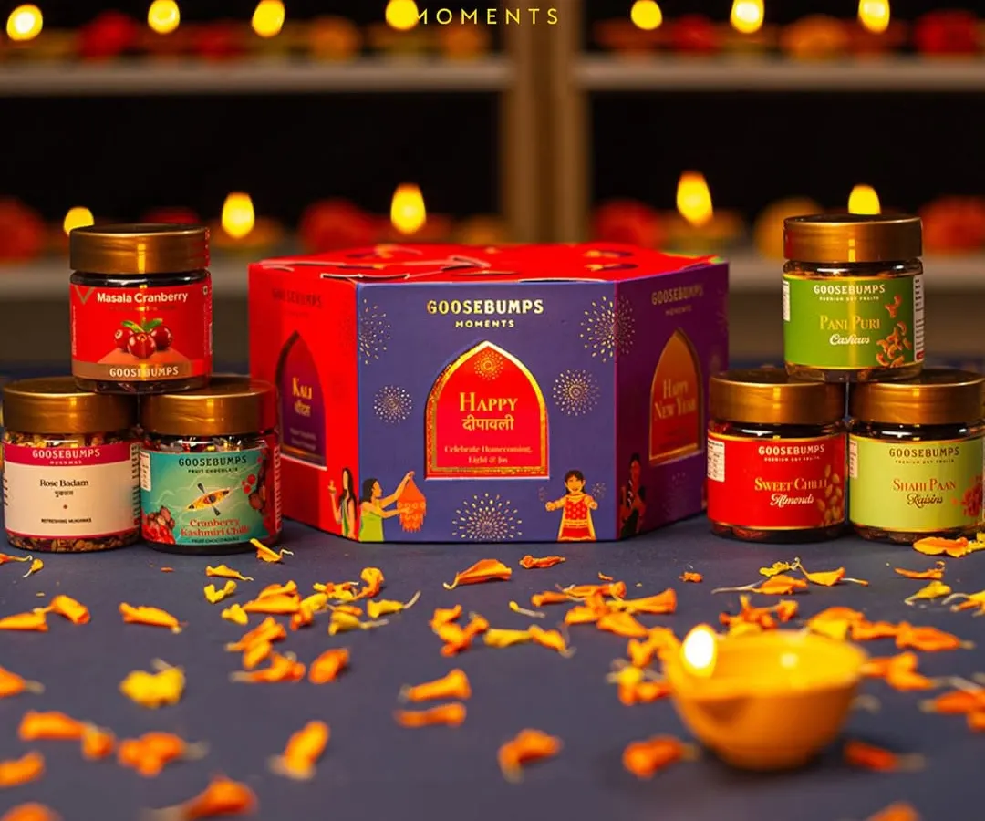 Here is my '6 Days of Celebration' Diwali hamper, laid out with all its treasures. The lantern-shaped box contains six different jars, including Pani Puri Cashews and Shahi Paan Raisins, each one celebrating a day of the festival.