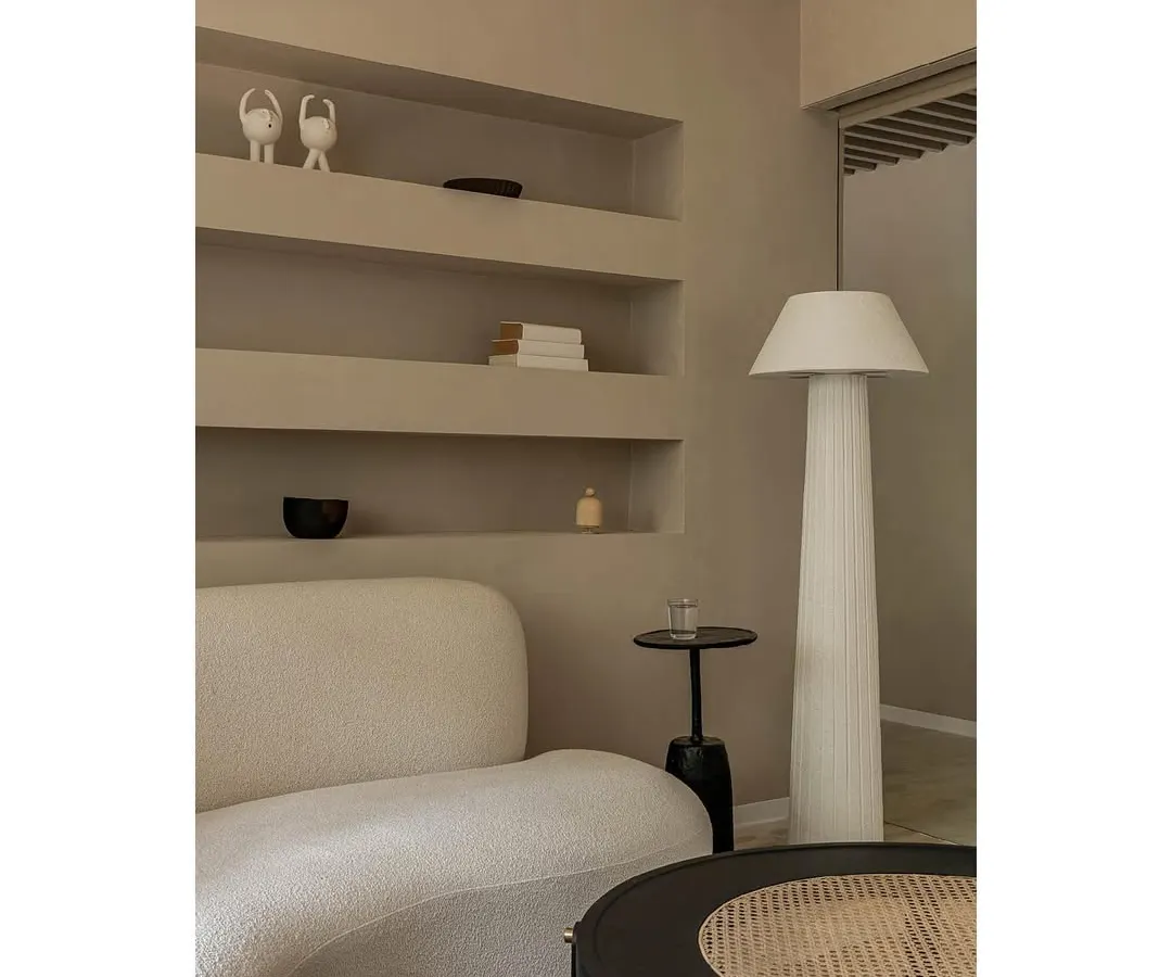 In this wellness lounge, we used a palette of soft, creamy tones and curved forms to create a space that feels both luxurious and deeply calming. The design features a custom bouclé sofa, built-in shelving niches, and carefully selected lighting to establish a serene atmosphere for clients.