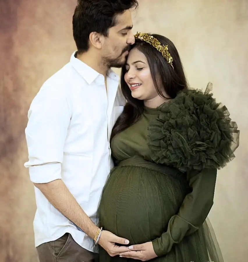 I love capturing the quiet connection between couples before their new journey begins. This tender moment, with a gentle forehead kiss, shows the love and anticipation that fills the air during a couple's maternity shoot.