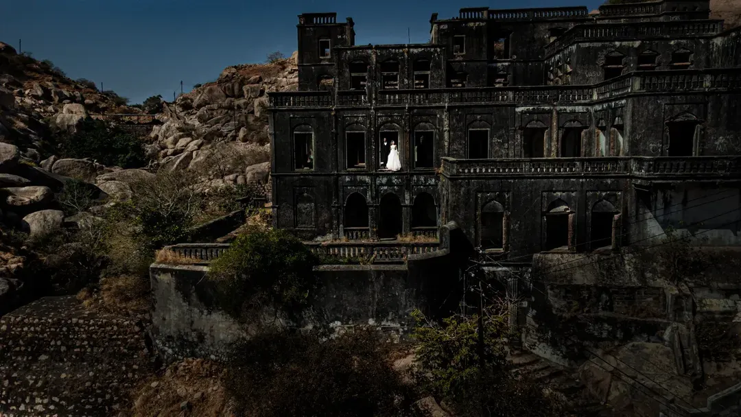 For me, it's about finding the perfect harmony between a couple and a grand landscape. This portrait, shot at the ruins of a forgotten palace in Gujarat, shows how we can create a sense of timelessness and scale, making your story feel truly epic.