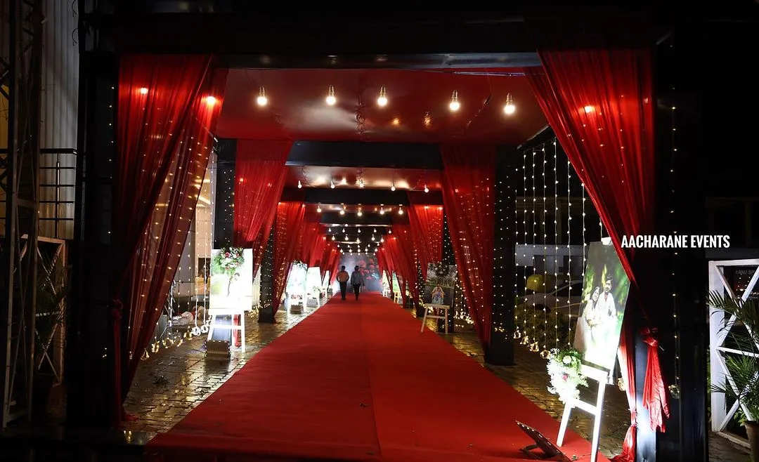 We believe the event experience should start at the entrance. A dramatic, fully draped red carpet walkway like this, illuminated with fairy lights, creates an immersive and high-impact welcome for guests at a product launch or celebratory dinner.