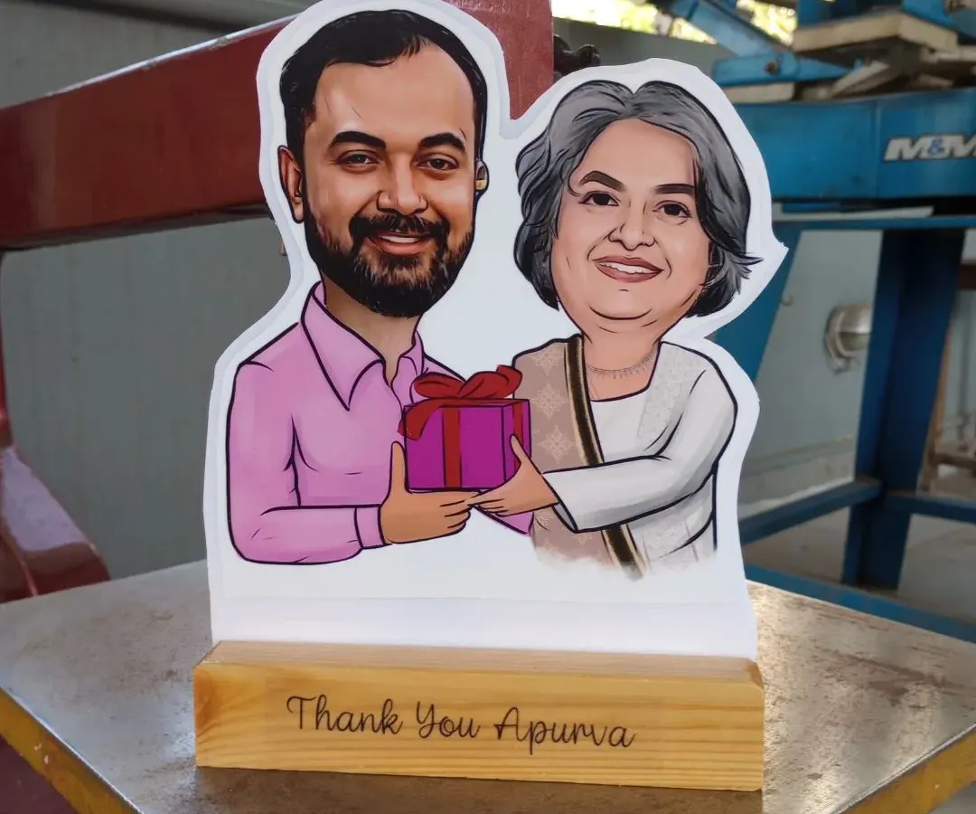 My caricature cut-outs are one of my most popular gifts. I turn a digital drawing into a physical statue with a custom message on a wooden base, perfect for farewells or as a thank you gift.