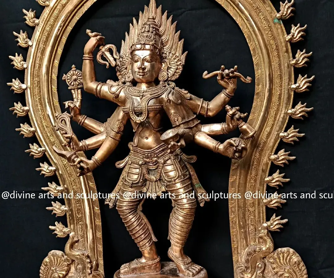 Here is our depiction of Bhadrakali, a fierce and protective form of the great Goddess. This 32-inch Panchaloha sculpture, framed by a traditional Prabhavali arch, captures her dynamic energy and intricate details, from the weapons in her hands to the cosmic dance of her posture.