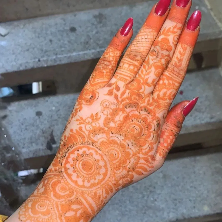 Here you can see the initial stain development on the back of a hand. This vibrant orange color appears right after the henna paste is removed and is a key sign of pure, chemical-free henna. This color will darken significantly over the next two days.