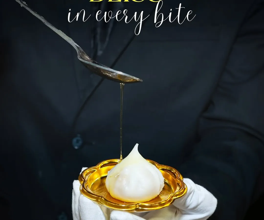 I believe in serving tradition with a touch of elegance. Here, one of my team members is drizzling golden ghee over a handcrafted Ukadiche Modak, a classic Maharashtrian sweet, presented on a golden plate for a truly royal feel.