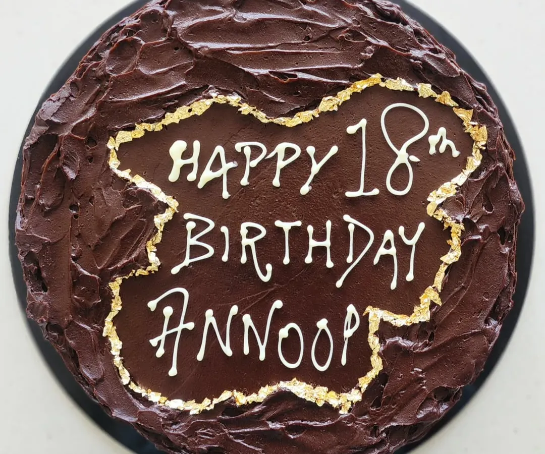 I made this rich dark chocolate ganache cake for a special 18th birthday. The rustic, textured chocolate finish with delicate gold leaf edging is one of my signature styles for milestone celebrations.