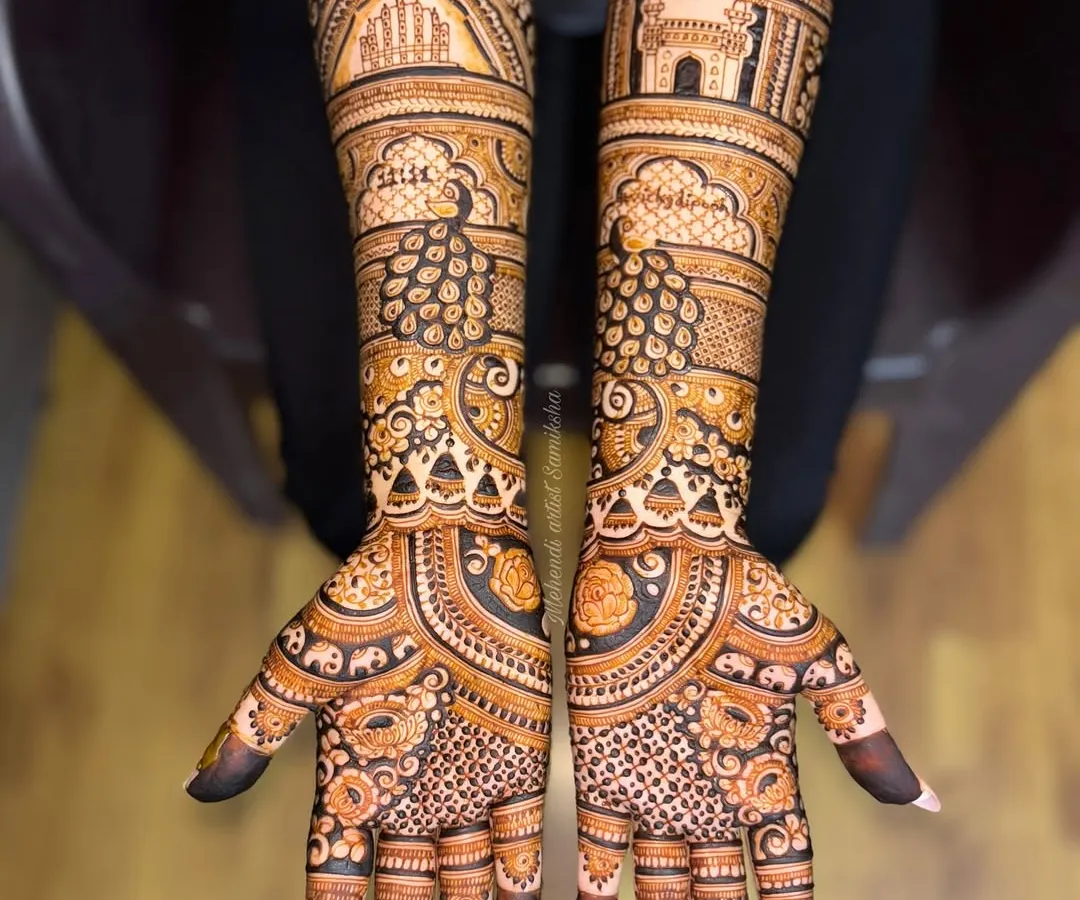 A tribute to the couple's heritage, this bridal design features Jaipur's Hawa Mahal on one arm and Hyderabad's Charminar on the other. Your love story, illustrated with intricate henna details.