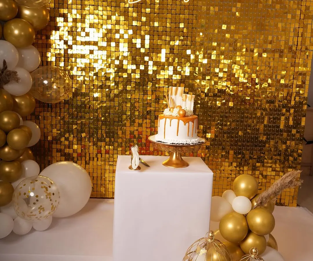 Here's a popular glam birthday setup featuring a gold shimmer wall that really catches the light. I paired it with a custom 'Happy Birthday' neon sign and a white and gold balloon garland for a complete party look.