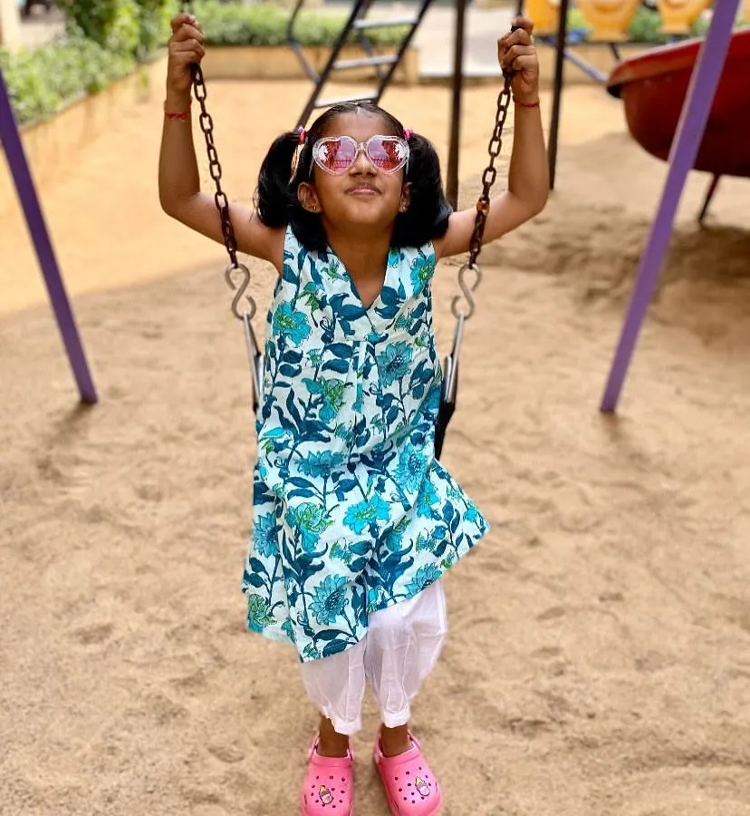 The pure joy of swinging high! I designed this 'Pakshi' (bird) print kurta to be versatile and fun. It's light enough for a warm day at the park and can be worn as a dress or paired with pants, making it a piece she'll reach for again and again.