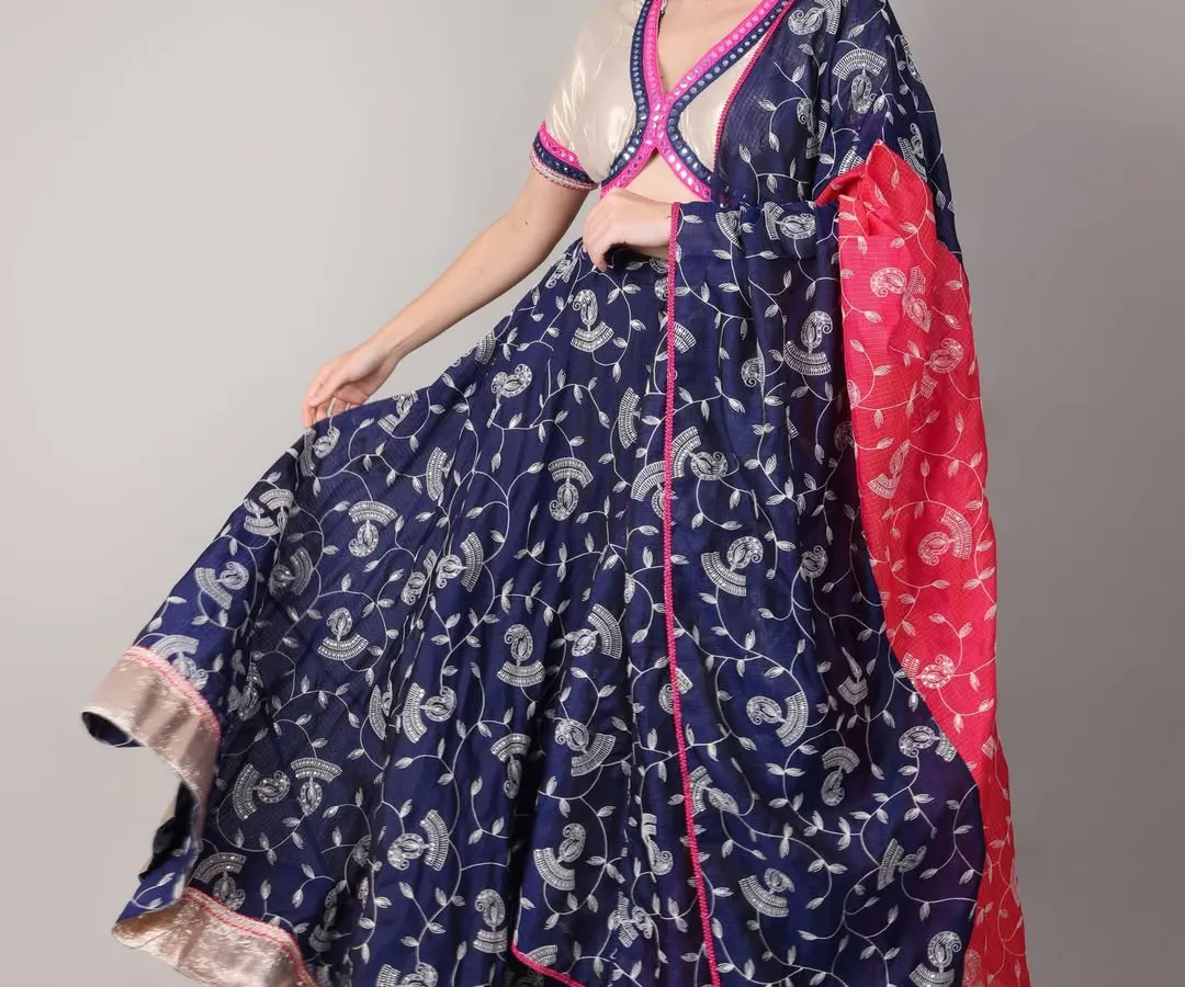 For Navratri, we created this royal blue lehenga set, perfect for a vibrant dandiya night. The flowing skirt allows for beautiful movement, while the off-white blouse with pink and blue mirror work trim adds a playful contrast. It’s a complete look that balances traditional charm with festive energy.