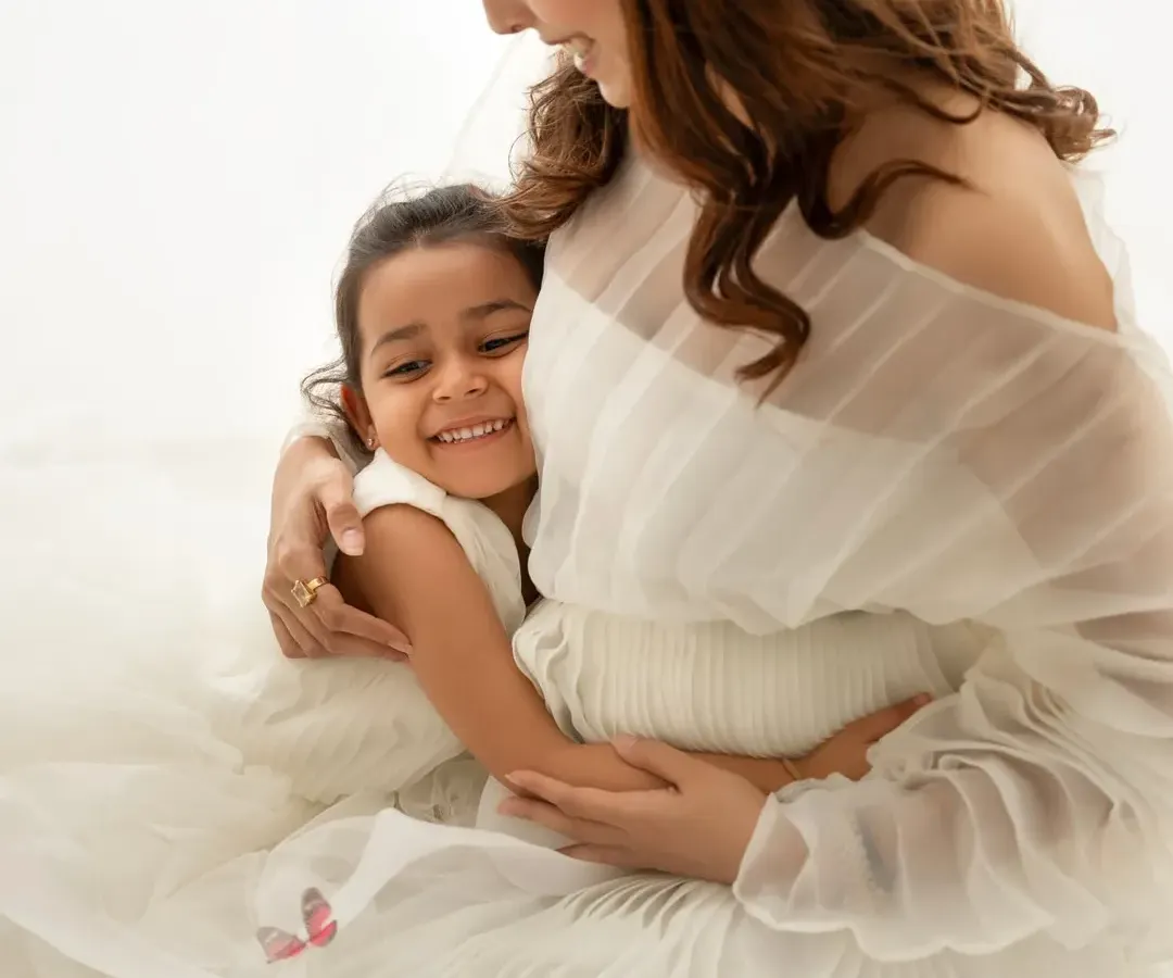 Welcoming a new baby is a family affair. I love including older siblings in my sessions, capturing these precious moments of bonding before the family grows. This sweet hug is a memory they'll both cherish forever.