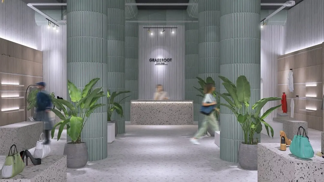 The welcoming entrance to the GRASSROOT retail store. The design uses fluted columns, terrazzo counters, and lush greenery to create a bright, natural, and calming atmosphere that invites customers to explore.