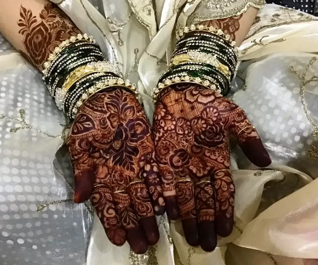 The final stain is everything. This photo shows the rich, reddish-brown color my natural henna develops into after a couple of days, beautifully complemented by the bride's traditional bangles.