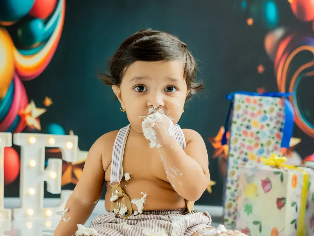 The pure joy of a first taste of birthday cake. I focus on capturing these genuine, unscripted moments during the cake smash session, resulting in photos full of personality and fun.
