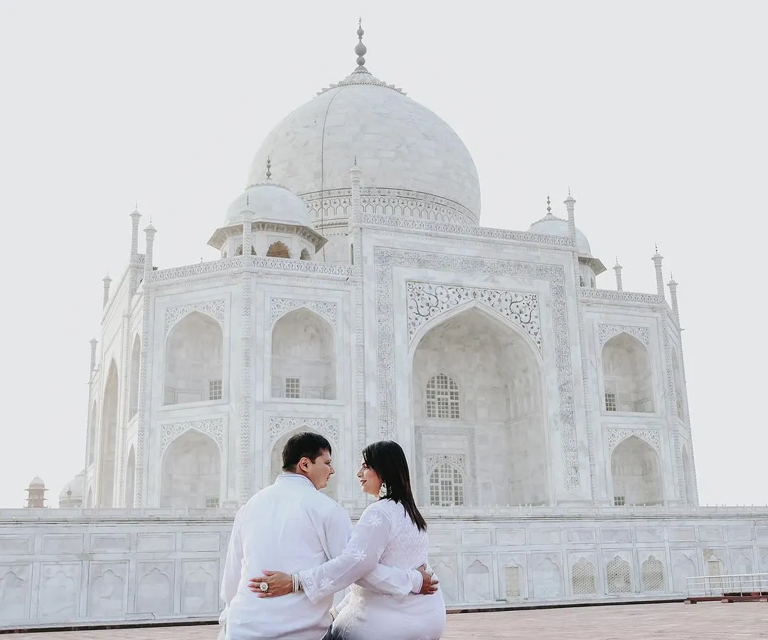 There is nothing more iconic than a pre-wedding shoot at the Taj Mahal. I focus on finding unique perspectives that frame this monument to love as a quiet backdrop to your own story, creating a timeless and elegant couple portrait.