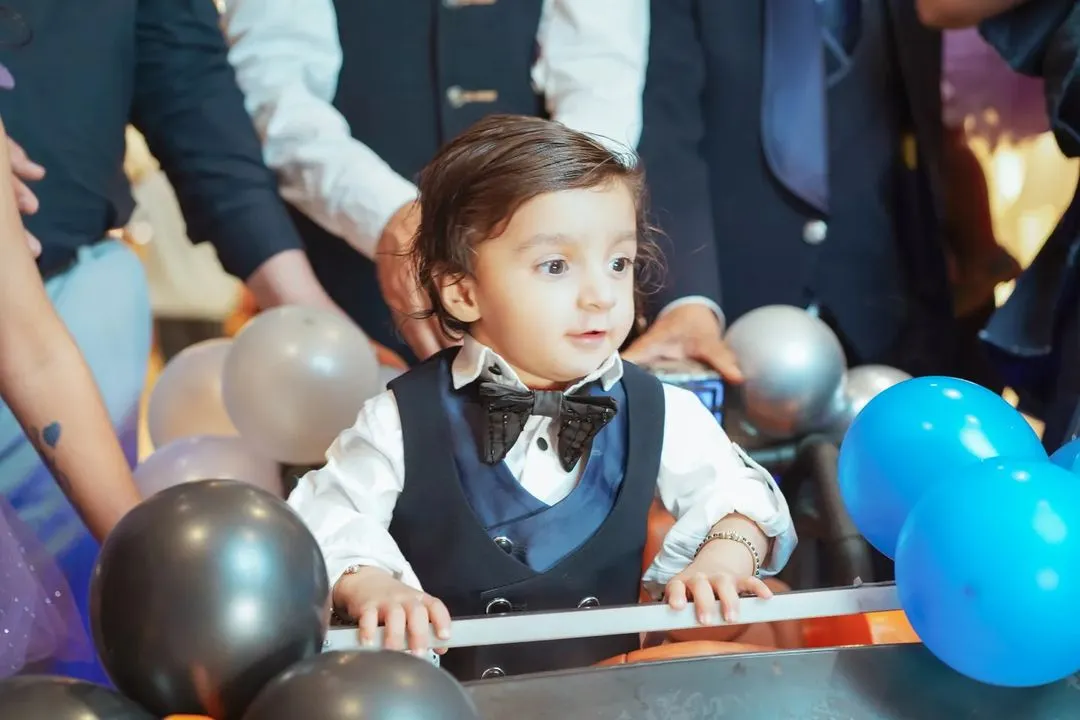 It's these unscripted, in-between moments that are pure magic. We focus on capturing your child's genuine expressions and personality, like this little one's curious gaze during his grand birthday entrance.