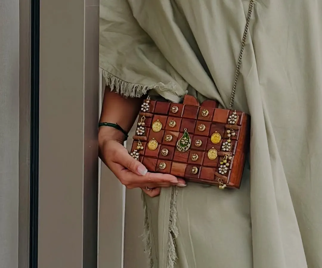 Here is a close up of my handcrafted wooden box clutch. I focused on the intricate details, from the polished wood blocks to the delicate embellishments, to create a piece that feels both rustic and luxurious. It's a unique accessory for a modern, earthy style.