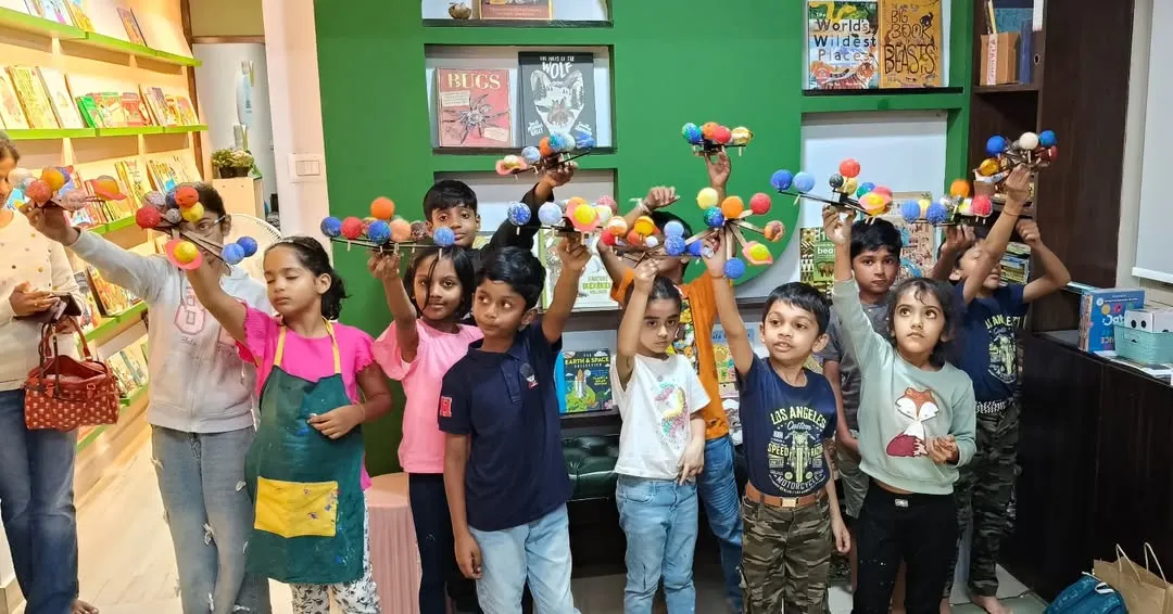 Our little astronomers proudly displaying the solar system models they built and painted themselves. This popular STEAM workshop combines learning about planets with hands-on assembly and creative painting.