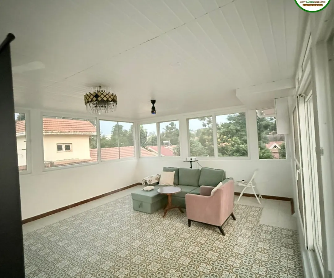 Imagine a bright, airy living room on your terrace. This is the interior of a fully enclosed gazebo, complete with a PVC ceiling, large UPVC windows, and stylish flooring. It's a perfect example of adding a functional and beautiful room to your home.