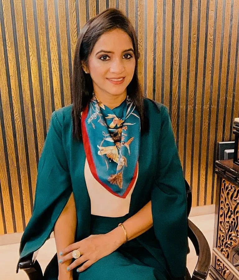 This is how I style myself for an important professional meeting. The structured green blazer paired with a complementary printed scarf creates a look that is both authoritative and approachable, ensuring you make a memorable first impression.