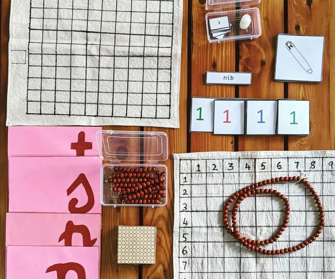 Each at-home kit is a treasure box of discovery, carefully prepared and handmade by me. This particular set includes materials for both math and language, like bead chains for counting, number cards, and phonetic object cards. It provides everything you need to bring a rich, hands-on learning environment into your home.