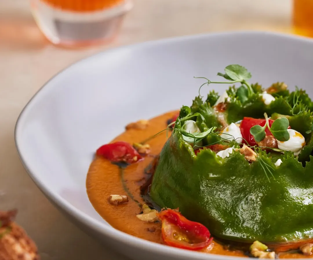 Our Spinach and Ricotta Crown Ravioli is a true signature. The pasta is handmade, of course, nestled in a charred tomato and miso sauce with toasted walnuts and goat's cheese for a hearty, comforting bowl.
