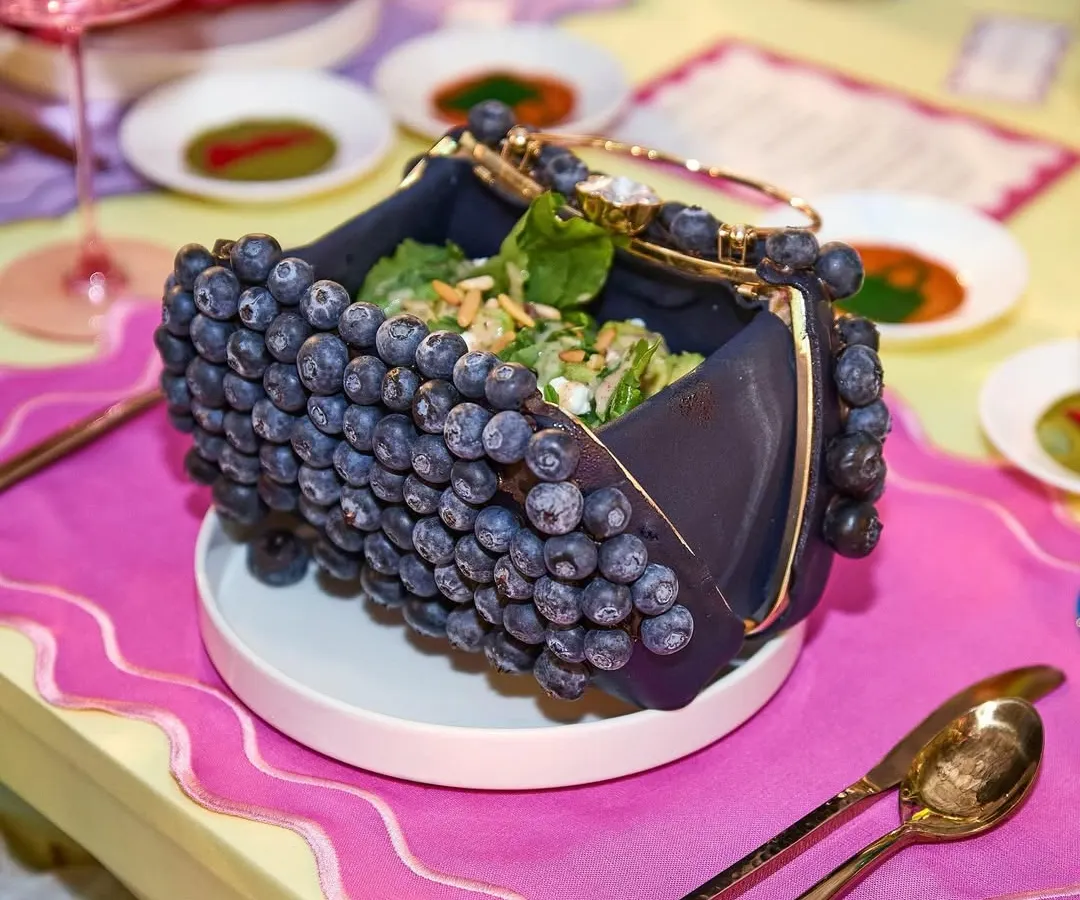 Why just carry a handbag when you can eat one? For a luxury fashion event, we created this playful salad served in an edible, blueberry-studded purse. It’s this blend of high fashion and culinary wit that defines our approach.