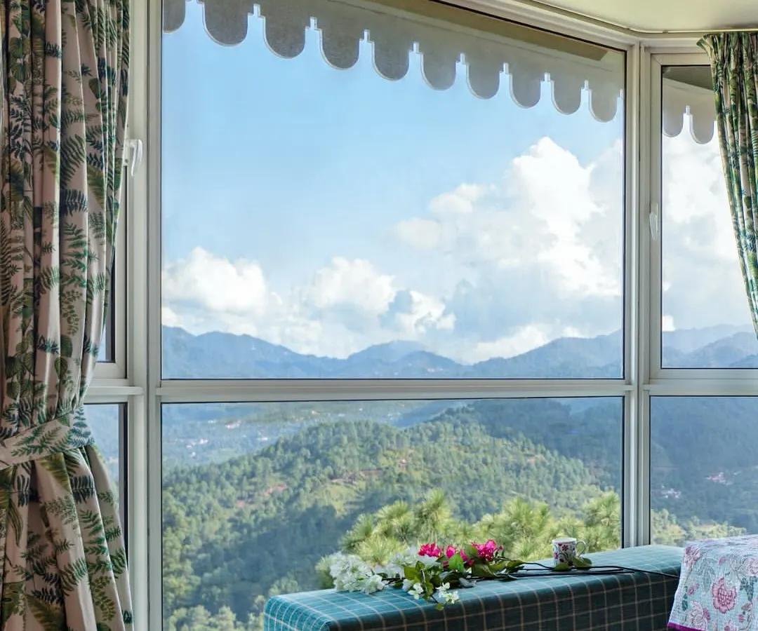 For us, the greatest luxury is a connection to nature. In this Kasauli mountain home, we designed the master bedroom's bay window not just as a feature, but as a destination for quiet contemplation, offering uninterrupted views of the Himalayan valley.