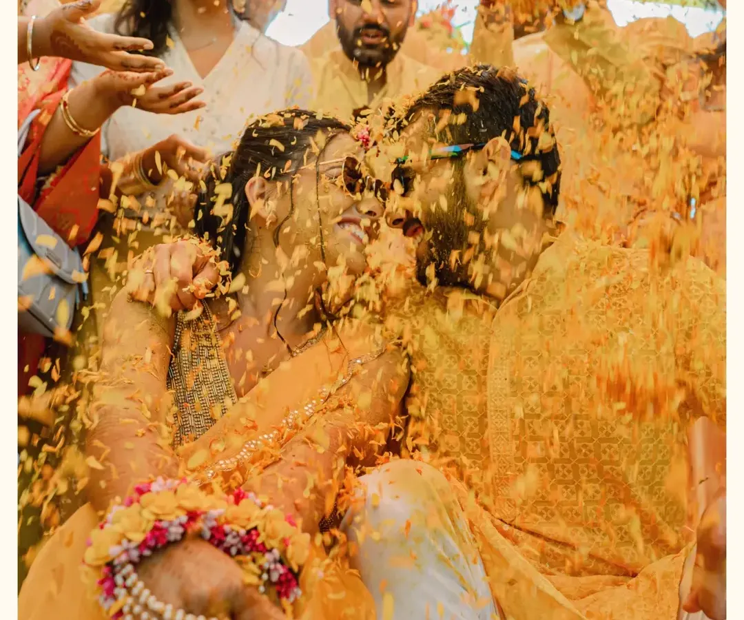 The Haldi ceremony is a beautiful chaos of color and joy. I focus on capturing the unscripted laughter and stolen glances amidst the shower of marigold petals.