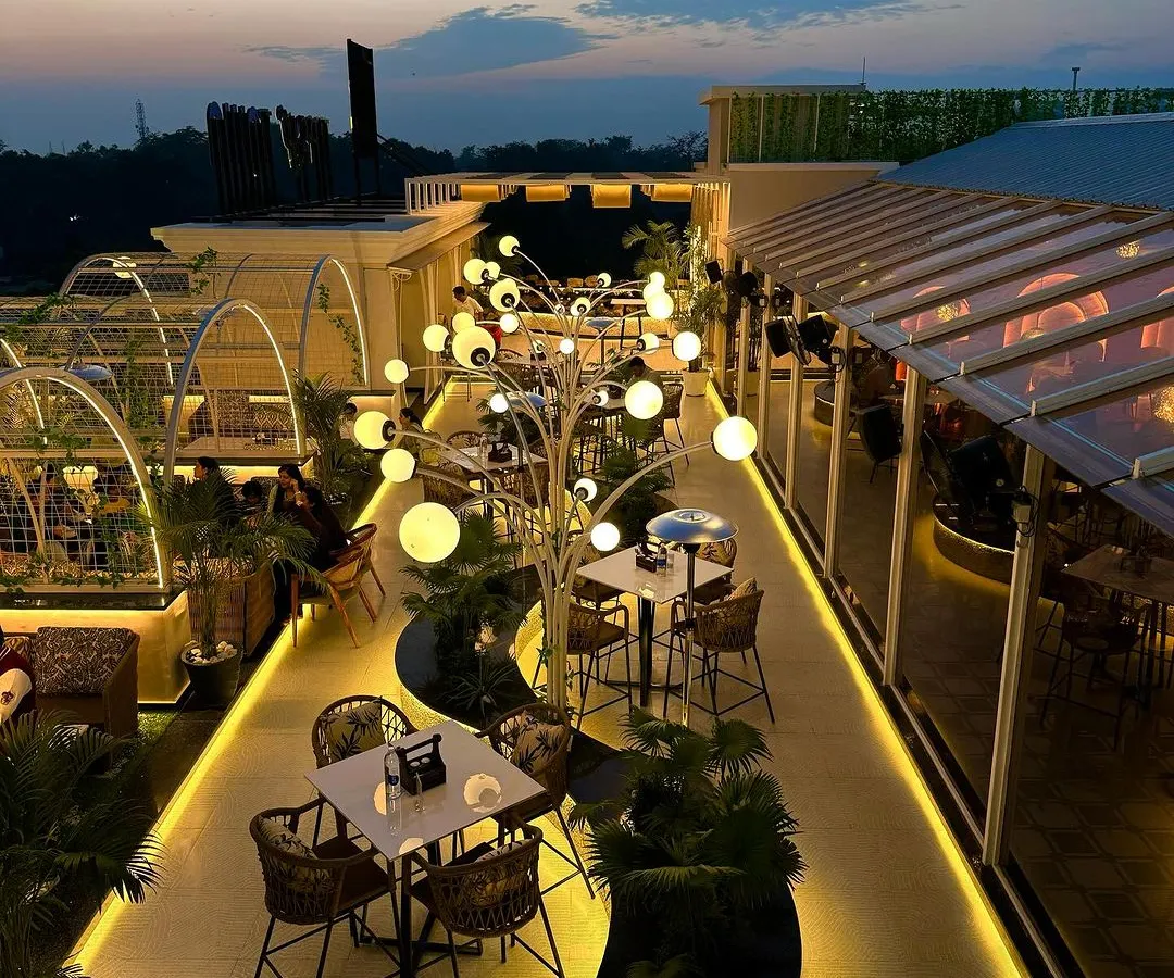 A view of the completed Tipsy Town rooftop in Ayodhya. My goal was to create an organic, flowing space where sculptural lighting and lush greenery guide you through different zones, making the entire rooftop feel like an enchanted garden.