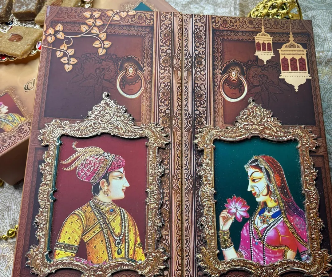 For a love story that feels like royalty, I designed this invitation inspired by timeless Indian miniature art. The Raja-Rani window portraits, set against a rich, textured background, create a regal and intimate announcement for your grand celebration.