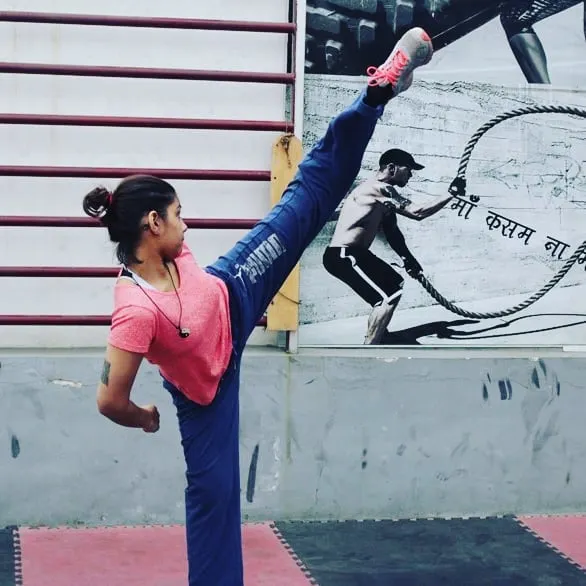 A student demonstrates excellent flexibility and control with a high kick. We work on building strength and agility in every class.