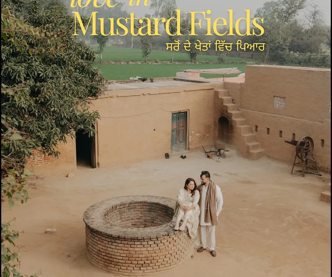 Love rooted in tradition, captured in the rustic heart of Punjab. This poster-style shot for Shreya and Tushar was designed to feel like the cover of their own classic love story, celebrating their heritage with a "sard de khetan vich pyaar" theme.