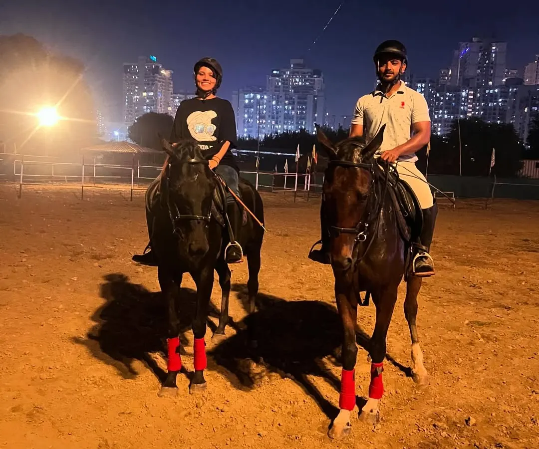 Our arena transforms after sunset, offering a unique location for a romantic couple's photoshoot. The dramatic glow of the Noida cityscape provides a stunning urban equestrian backdrop.