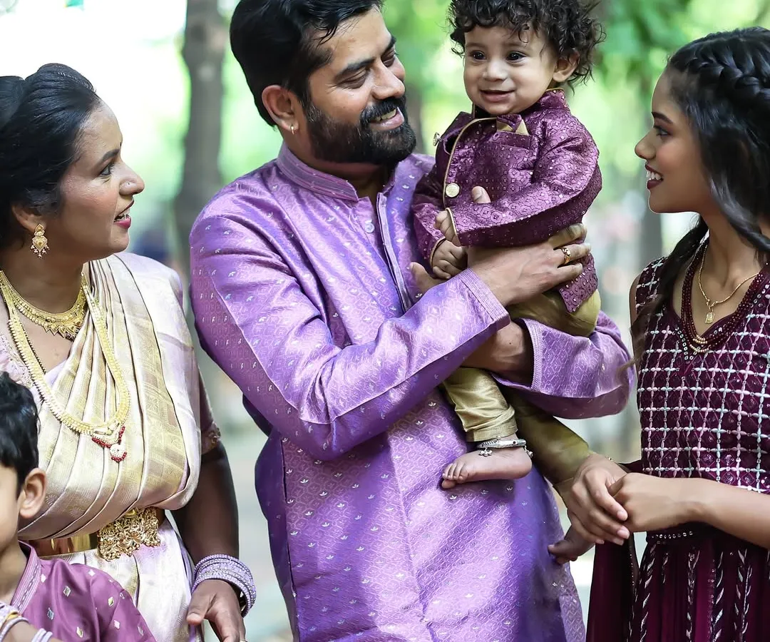 A candid family portrait taken outdoors. I love capturing the natural interactions between parents and their children in a relaxed setting.