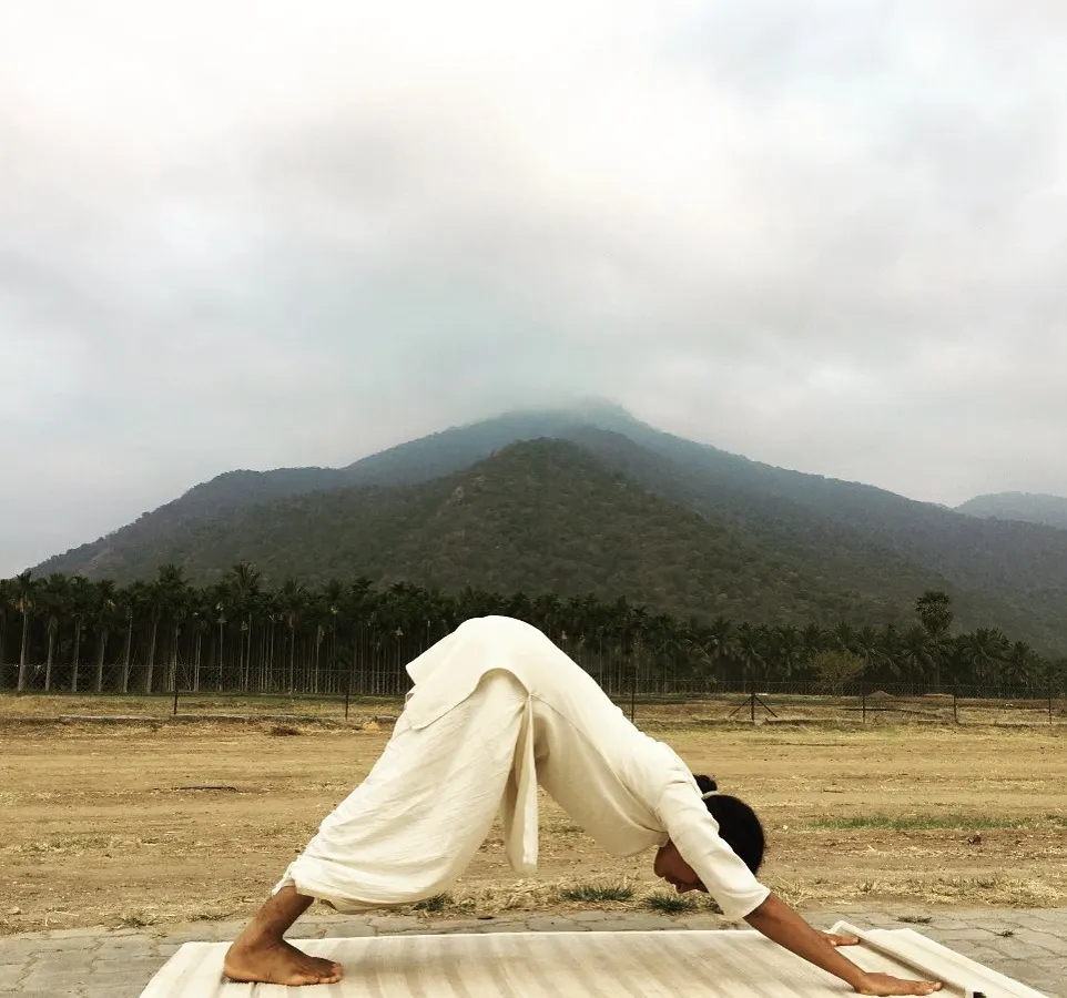 This is me practicing with the Velliangiri mountains in the background. I didn't get into yoga for health or to become a teacher. I was just curious, and it stuck. This practice is not about looking perfect, it's about showing up, even when it's a challenge.