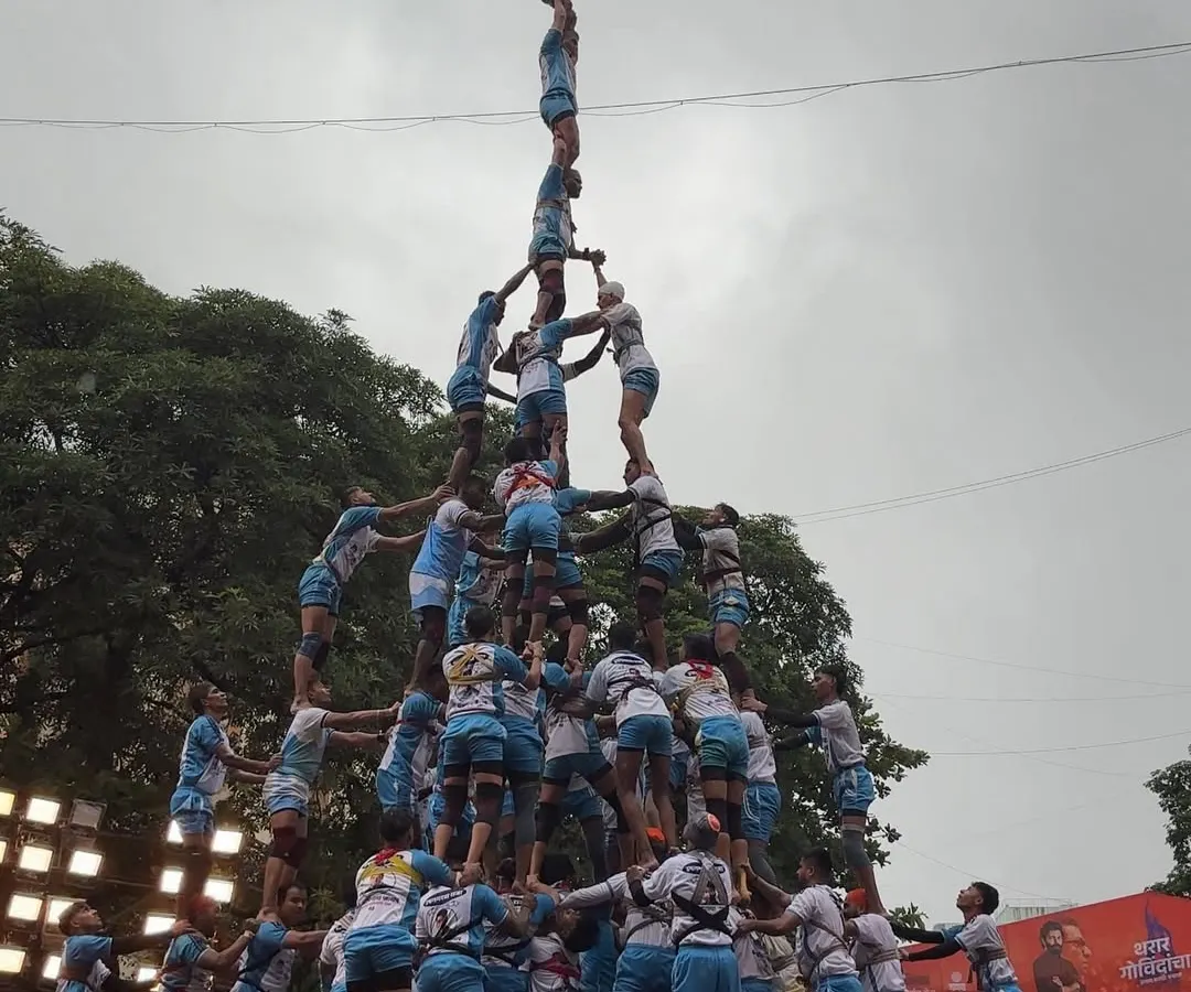 Freezing a moment of pure adrenaline and teamwork. This shot captures a Govinda pathak creating a 10-tier human pyramid during Dahi Handi, a testament to the spirit and strength I focus on documenting.